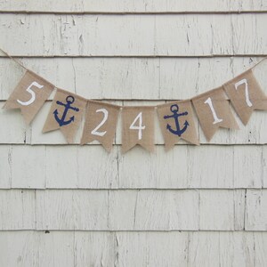 May include: A burlap banner with white numbers and a blue anchor, spelling out "5 24 17".