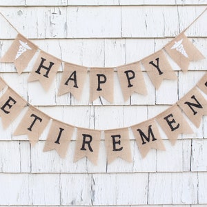 May include: A burlap banner with the words "Happy Retirement" in black lettering. The banner is decorated with two small white medical caduceus symbols.