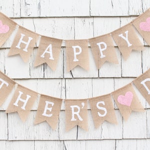May include: A burlap banner with pink hearts and the text "Happy Mother's Day" in white letters.