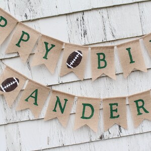 May include: A burlap banner with the words "Happy Birthday" and a football graphic. The banner also says "Anderson" with a football graphic.