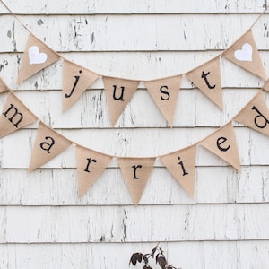 May include: A burlap banner with white hearts and the words 