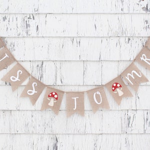 May include: A burlap banner with the words "Miss to Mrs" in white lettering. The banner is decorated with red and white mushroom illustrations.