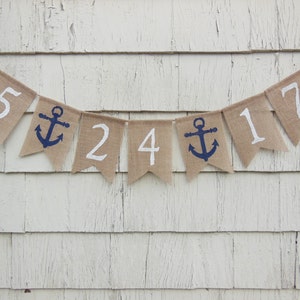 May include: A burlap banner with white numbers and blue anchors. The banner reads "5 24 17".