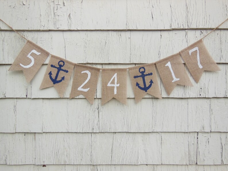 May include: A burlap banner with white numbers and blue anchors. The banner reads "5 24 17".