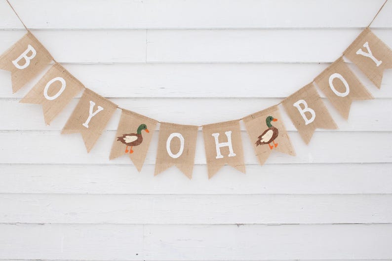 May include: A burlap banner with the words "Oh Boy" and two ducks, perfect for a baby shower or gender reveal party.