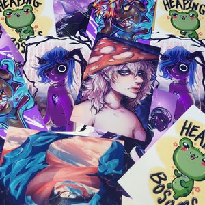 May include: A collection of colorful stickers featuring various illustrations. The stickers include a mushroom with a face, a purple character with a heart, a green frog with the text "Heaping Bosoms", and a blue and purple character with a black eye.