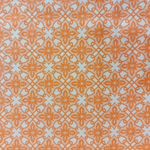 May include: A seamless pattern of orange floral designs on a white background. The pattern is made up of repeating squares with intricate floral details.