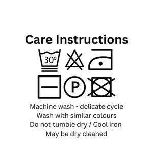 May include: White background with black text and laundry care symbols. Text reads "Care Instructions" above symbols for washing, drying, and ironing. Additional text includes "Machine wash - delicate cycle" and "Wash with similar colours."