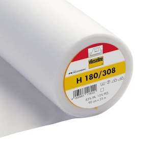 May include: A white roll of Vlieseline H 180/308 interfacing fabric. The label is yellow with black text and a barcode. The label says "85% PA, 15% PES, 90 cm x 25 m".