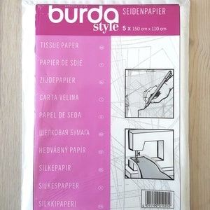May include: A pack of 5 sheets of white tissue paper, labelled "Seidenpapier" and "burda style". The pack is 5 x 150 cm x 110 cm. The tissue paper is for sewing and crafting.