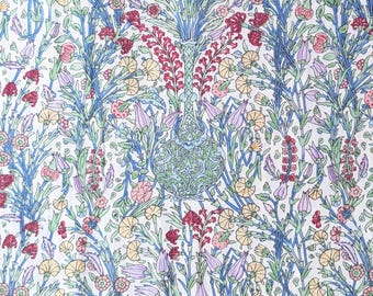 May include: A detailed floral pattern featuring a central vase design. The pattern includes a variety of flowers in shades of red, pink, yellow, and purple, set against a white background. Blue stems and leaves create a structured, yet organic, design.