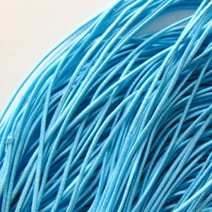 May include: A bundle of light blue elastic cord, ideal for crafting projects.