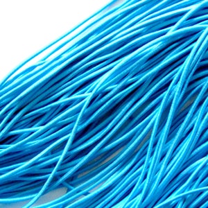 May include: A close-up of a bundle of bright turquoise elastic cord. The cords are thin and flexible, with a smooth texture. The image shows the details of the material. The cords are likely used for crafting or jewellery making, and are a vibrant blue colour.