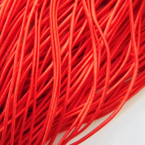 May include: A bundle of bright red elastic cord, perfect for crafting projects.