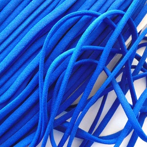 May include: A close-up of a bundle of bright blue suede cord. The cord is soft and flexible, and it is ideal for crafting projects.