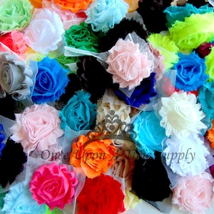 May include: Assortment of colorful fabric flowers with ruffled edges. The flowers are made of soft, sheer fabric and are arranged in a variety of colors, including pink, blue, green, orange, red, and white.