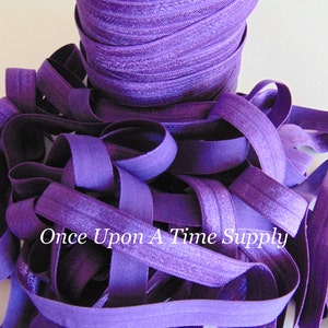 May include: A close-up of a spool of purple elastic, with the text "Once Upon A Time Supply" visible in the image.