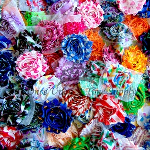 May include: A collection of colorful fabric flowers, featuring a variety of patterns and textures. The flowers are made from different fabrics, including stripes, polka dots, and floral prints. The flowers are arranged in a random order, creating a visually appealing and vibrant display.
