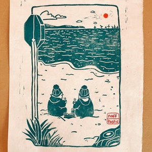 Linoprint of two wild swimmers enjoying pastries on the beach. Printed in turquoise ink with a red sun.