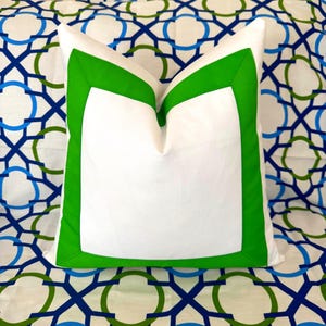 May include: A white ceramic mug with a black handle and the text "But First, Coffee" in a bold, black font. The mug is set against a blurred background, suggesting a cozy setting.