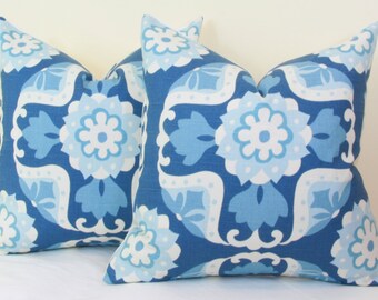 May include: Two blue and white patterned throw pillows with a floral design. The pillows are made of a soft, comfortable fabric and are perfect for adding a touch of style to any room.