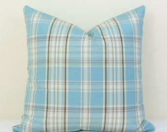 May include: A blue and white plaid pillow with brown and green accents. The pillow is made of a soft, comfortable fabric and is perfect for adding a touch of style to any room.