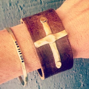 May include: A set of three ceramic mugs with a speckled, matte finish. The mugs are in shades of cream, light gray, and dark gray. Each mug has a simple, minimalist design, perfect for coffee or tea.