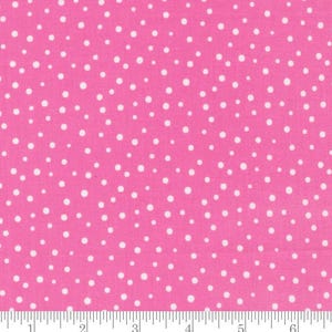 May include: Pink fabric with a white polka dot pattern. The fabric is shown with a ruler for scale.