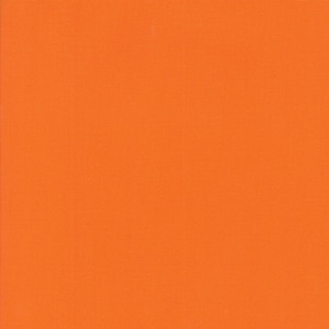 May include: Solid orange fabric swatch. The fabric has a smooth, even texture.