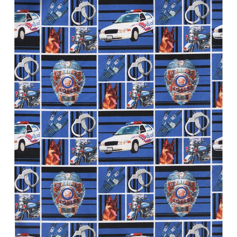May include: A blue and black fabric with a repeating pattern of police cars, motorcycles, German Shepherd dogs, handcuffs, and police badges. The fabric has the words "Police" and "Officer" printed on it.