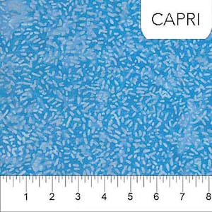 May include: A blue fabric with a white speckled pattern. The fabric is called "Capri".