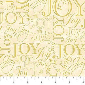 May include: A cream-colored fabric featuring a repeating pattern of the word Joy in various gold-toned fonts and sizes, interspersed with small sprigs of holly. A white ruler with black markings is visible at the bottom, measuring up to 6 inches.