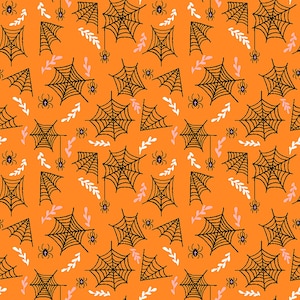 May include: An orange fabric featuring a repeating pattern of black spiderwebs and small spiders, interspersed with delicate white and light pink leafy sprigs. A ruler at the bottom shows a scale of 6 inches for size reference.
