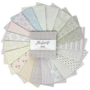 May include: A collection of fabric squares in various pastel colors, arranged in a circular pattern. The squares feature different geometric and floral designs. A central bundle of fabric squares is wrapped with a label that reads "FreeSpirit".