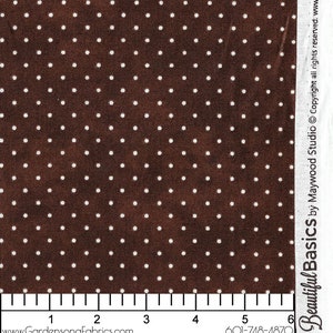 May include: Close-up of brown fabric with a white polka dot pattern. The fabric has a ruler along the bottom edge and the text "www.GardensongFabrics.com" and "601-748-4870". The fabric is from Beautiful Basics by Maywood Studio.