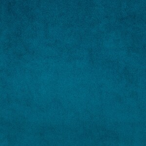 May include: A solid teal blue background with a slightly textured surface.