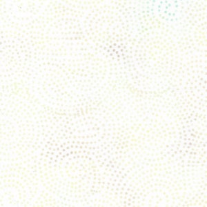 May include: Off-white fabric with a pattern of small, evenly spaced dots. The dots vary in color, including pale yellow, light brown, and a hint of blue. The overall effect is a subtle, textured design.