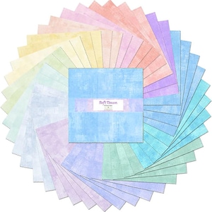 May include: A collection of pastel-colored fabric squares arranged in a circular pattern. The squares feature a textured design and a variety of colors, including pink, blue, green, and yellow. The center square has the text "Soft Dawn".