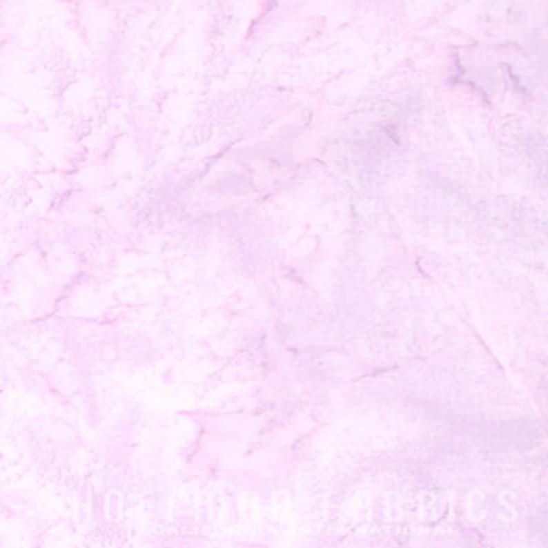 May include: A light lavender fabric featuring a subtle, mottled batik-style pattern with varying shades of soft purple and white. The surface displays a textured, marbled appearance with organic, cloud-like shapes throughout the textile material.