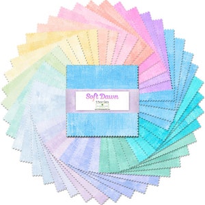 May include: A collection of fabric squares in a circular arrangement, showcasing a pastel color palette of blues, pinks, yellows, and greens. The center features a label with the text "Soft Dawn". Each square has a textured appearance.