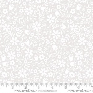 May include: White floral fabric with a delicate pattern of small white flowers and leaves on a light gray background. The fabric is shown with a ruler for scale.