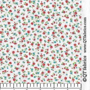 May include: White fabric with a repeating pattern of small red and blue flowers. A ruler is included to show the scale of the fabric. The ruler shows measurements in inches. The text on the ruler reads "Gardensong Fabrics" and "601-748-4870".