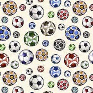 May include: A pattern of soccer balls in various sizes and colors, including white, black, red, blue, green, and gold. The balls are arranged on a cream-colored background.