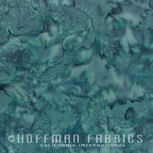 May include: Teal blue batik fabric with a swirling, marbled pattern. The fabric is made by Hoffman Fabrics, California International.