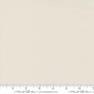 May include: A solid white fabric swatch with a subtle texture. The fabric is shown with a ruler for scale.