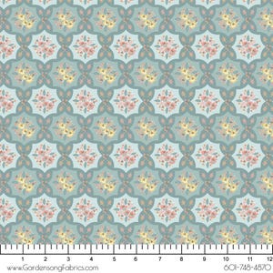 May include: A repeating pattern of floral bouquets in shades of pink, yellow, and peach, set against a light teal background. The design features a symmetrical arrangement of flowers within a geometric, quatrefoil-like shape. The fabric has a ruler at the bottom with the text "www.GardensongFabrics.com".