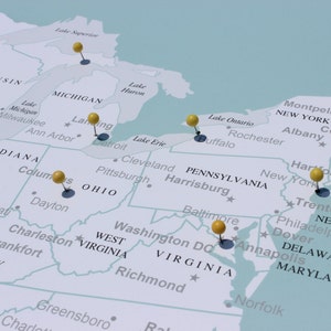 May include: A map of the United States with yellow push pins marking various locations. The pins are placed on major cities and states, including New York, Boston, Chicago, Los Angeles, and San Francisco.