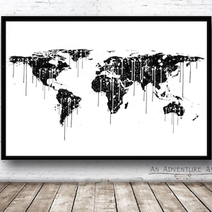 May include: Black and white world map print with a dripping paint effect. The map is framed in a black frame and the text "An Adventure Awaits" is below the frame.