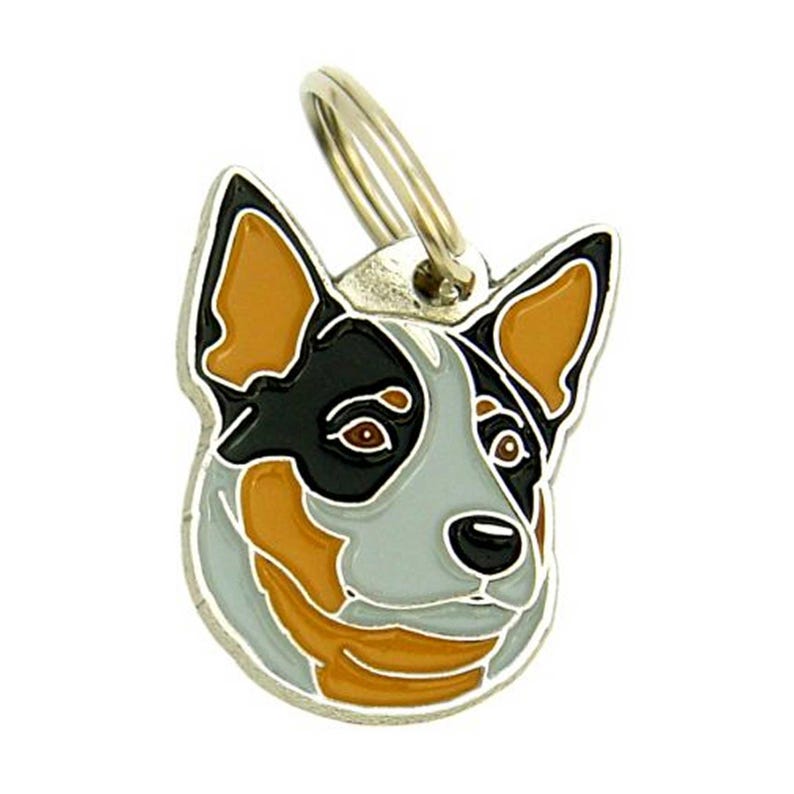 May include: A dog tag featuring a stylized image of a dog's head. The tag has a silver-colored metal ring at the top. The dog's face is depicted with black, tan, and gray colors, with brown eyes and a black nose.