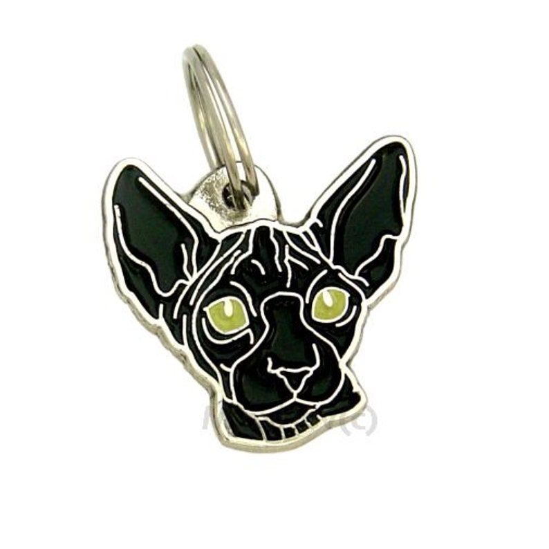 May include: A silver metal keychain featuring a black Sphynx cat with green eyes. The cat's head is facing forward with its ears perked up.